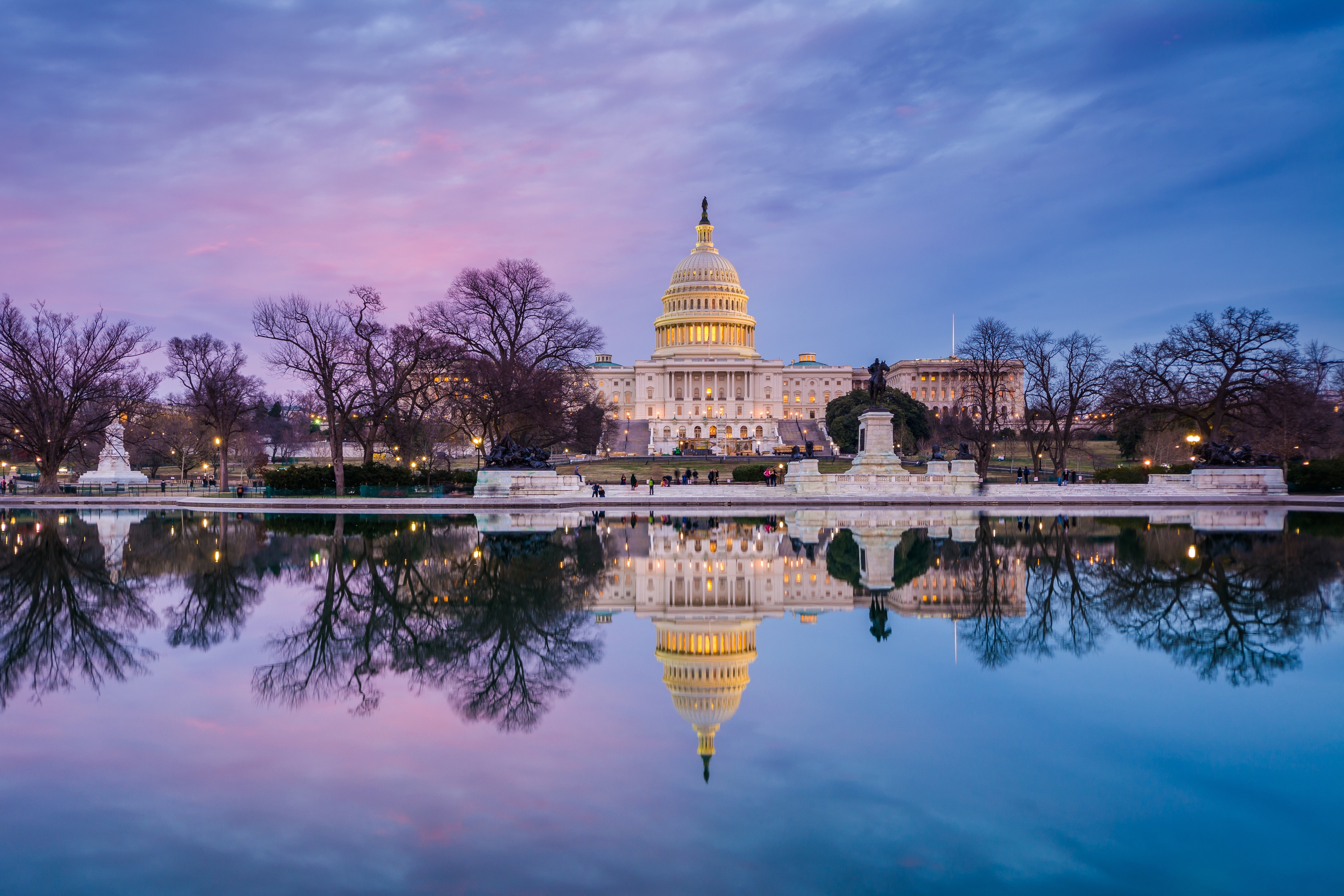 Washington D.C. U.S. Capitol at sunset with colorful sky and reflection in the Capitol Reflecting Pool