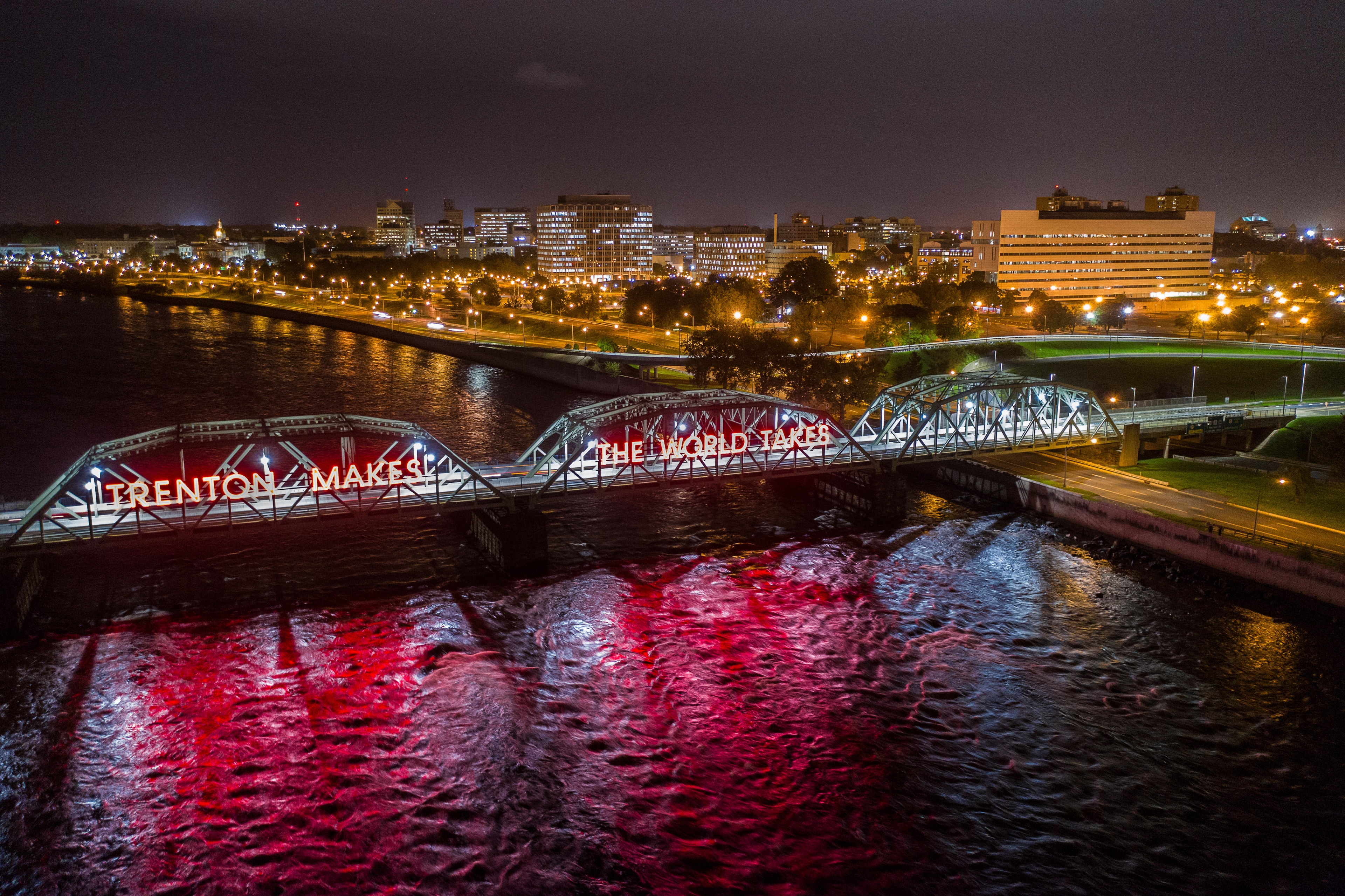 Night view of Trenton, New Jersey with the ‘Trenton Makes, The World Takes’ bridge over the Delaware River, representing regional records management, storage, and shredding service coverage in the Trenton market.