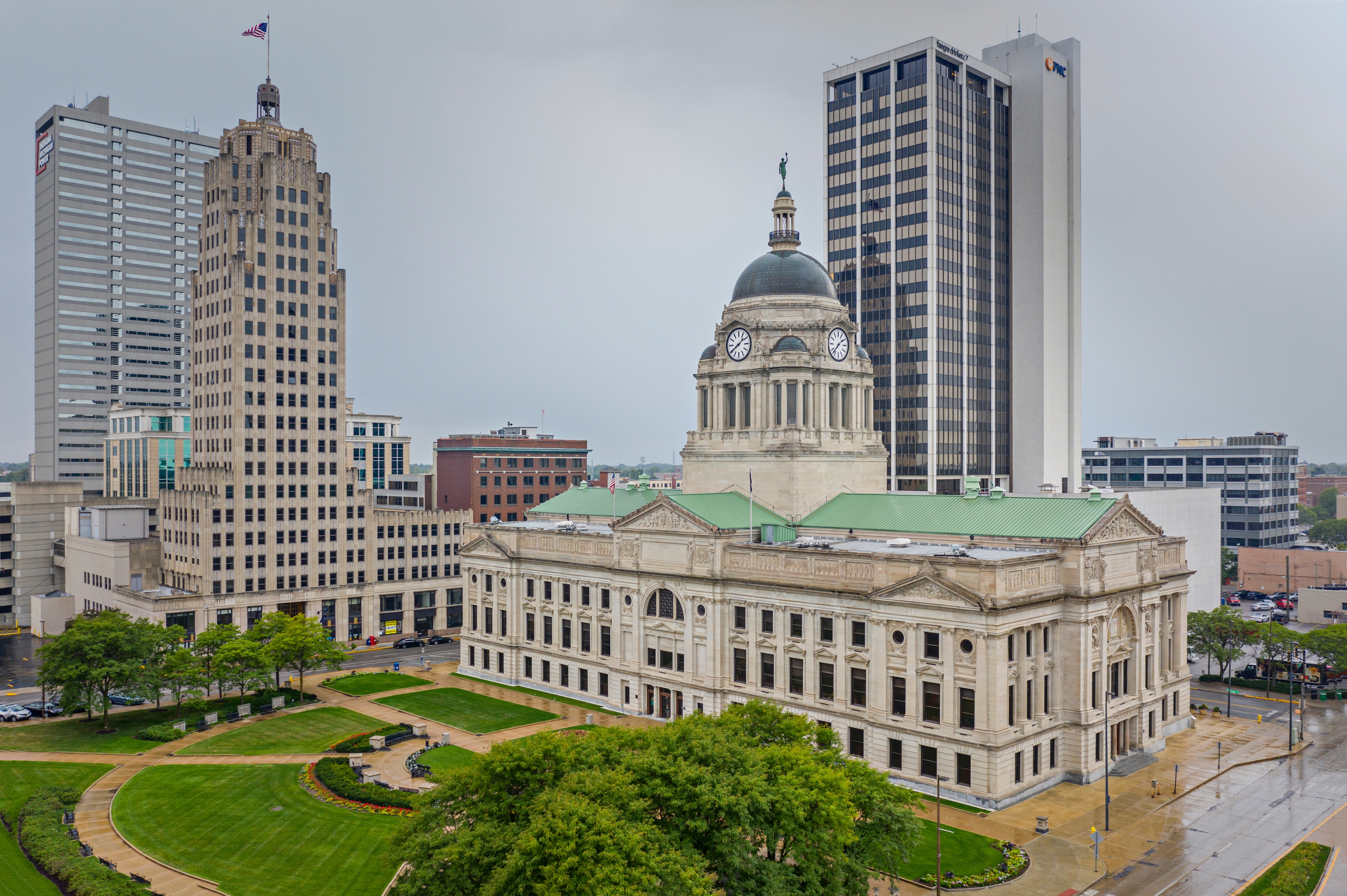 Downtown Fort Wayne, Indiana featuring the historic Allen County Courthouse with its domed roof and surrounding modern office towers on a rainy day.