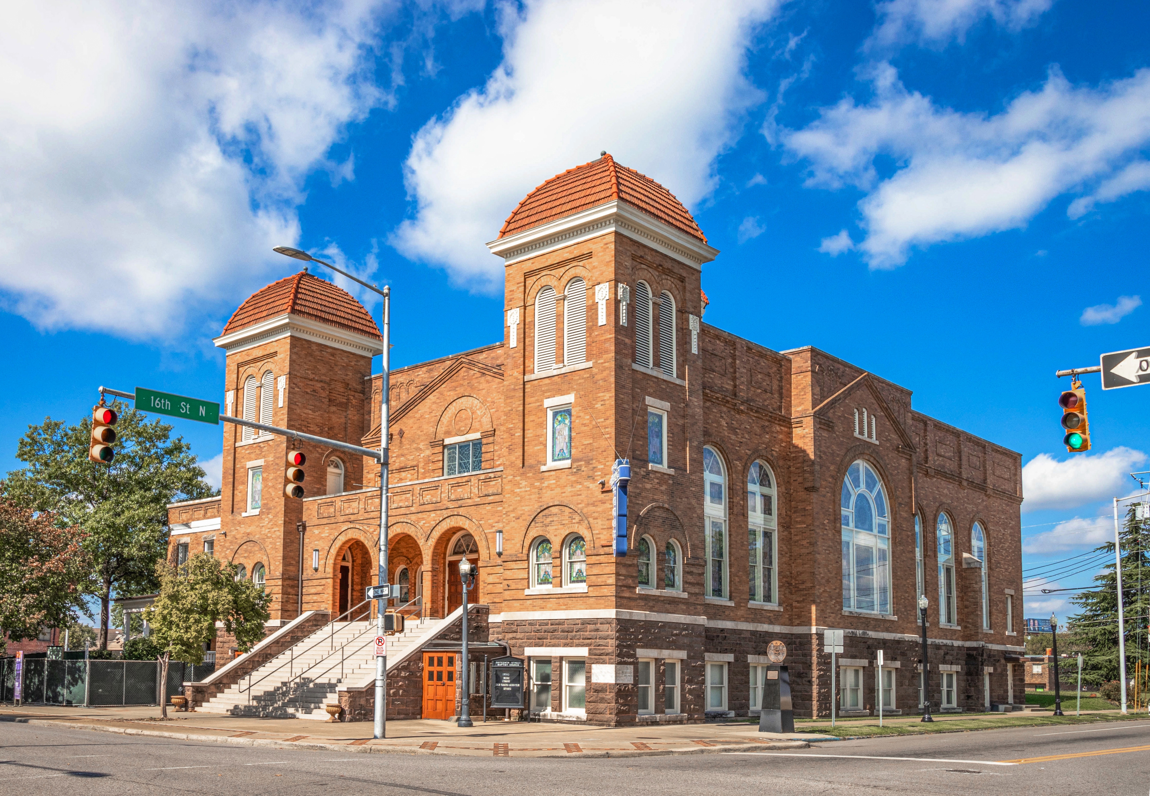 Historic 16th Street Baptist Church in downtown Birmingham, Alabama, featuring red brick architecture and twin towers.