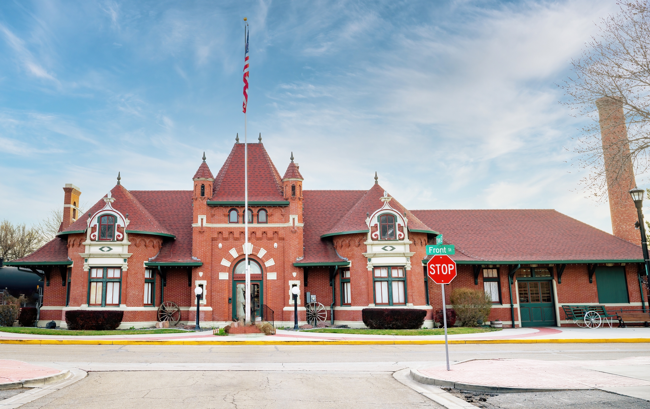 The Nampa Train Depot, a red-brick historic building in Nampa, Idaho, featuring a steep red roof and ornate windows.