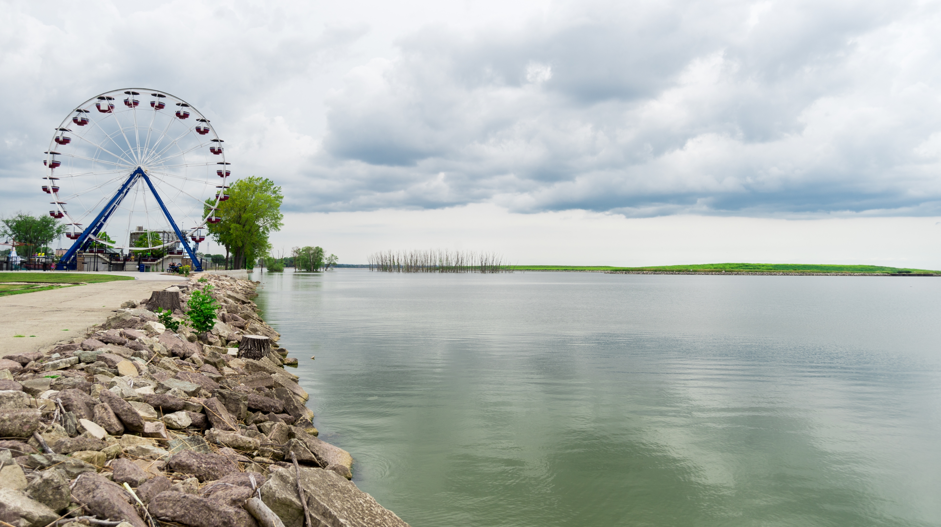 Ferris wheel along the waterfront at Lake Kampeska in Watertown, South Dakota, beneath a cloudy sky.