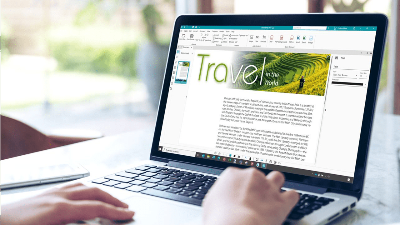 A close-up of a laptop screen displaying a document editing software with a vibrant travel-themed cover page. The user’s hands are visible, operating the laptop in a bright, naturally lit workspace.