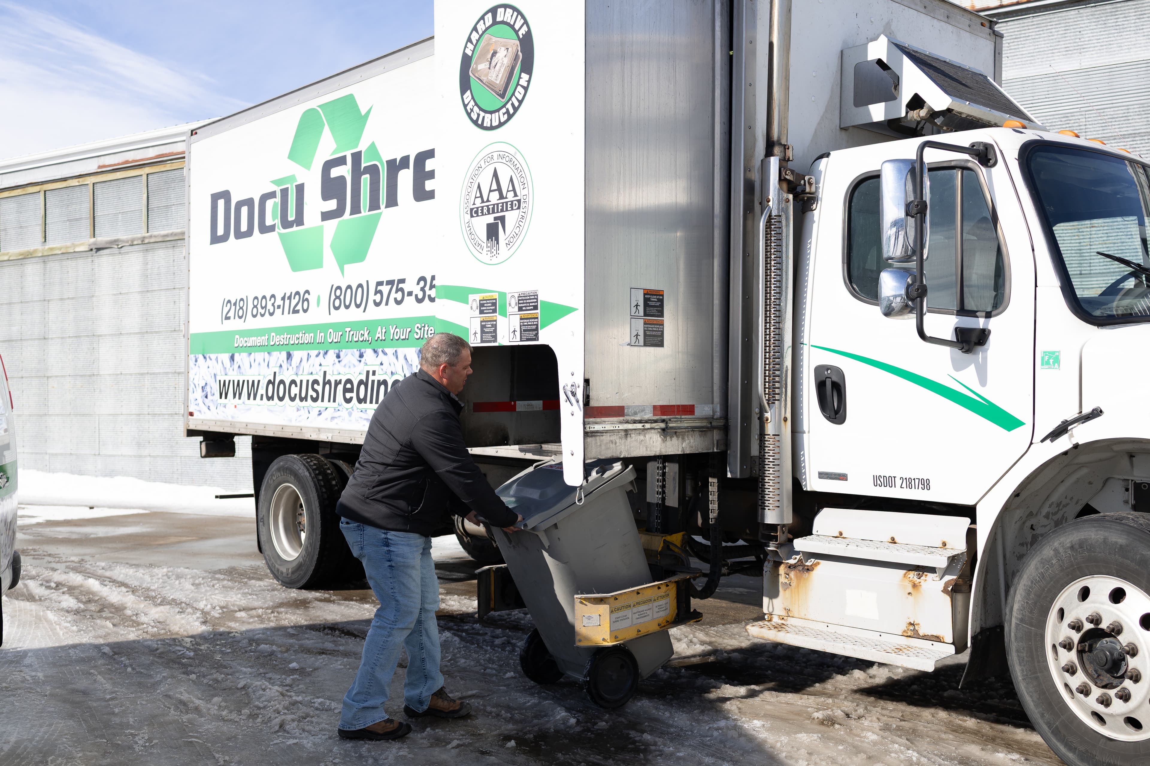 On-site mobile shredding truck providing secure document destruction services with NAID AAA certification for compliance and data security.