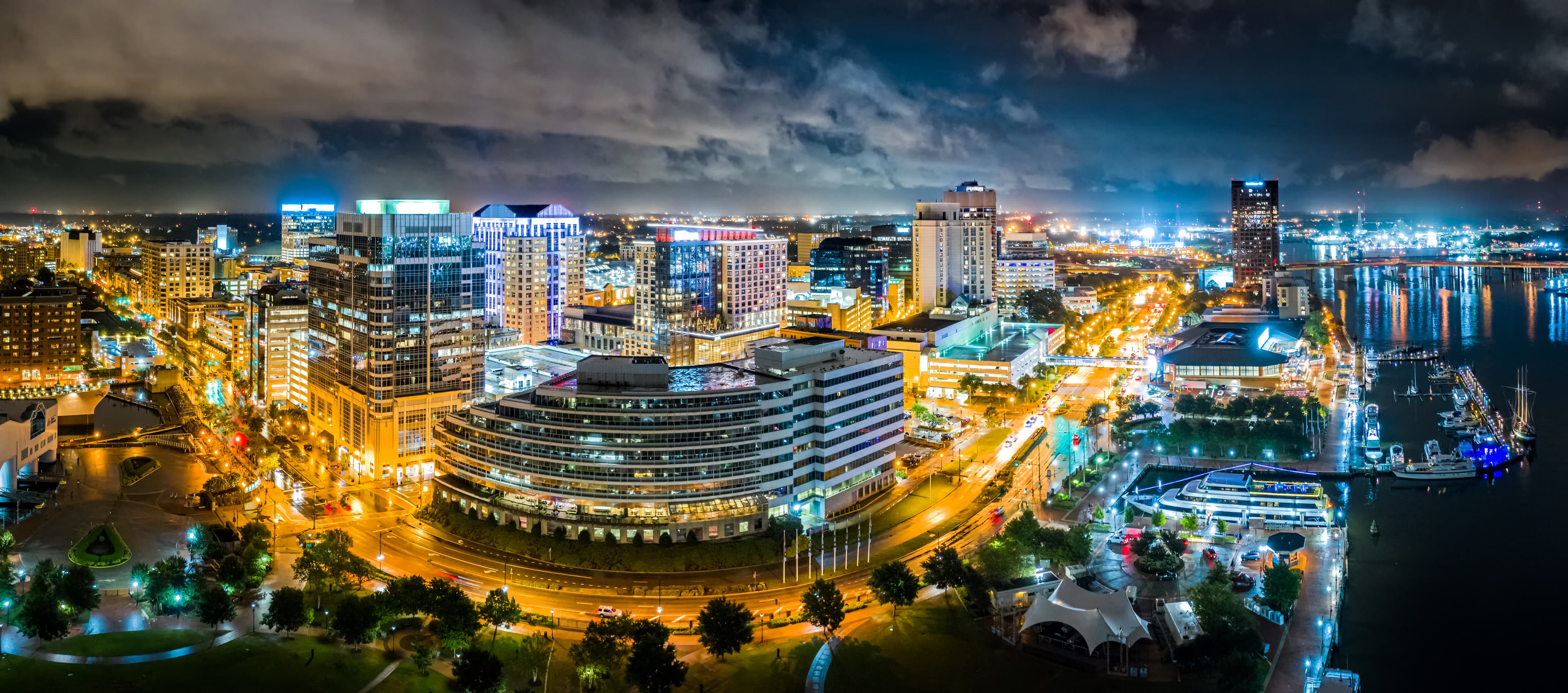 Aerial panorama of Norfolk Virginia by night. Norfolk is the second-most populous city in Virginia after neighboring Virginia Beach and the host of the largest navy base in the world.