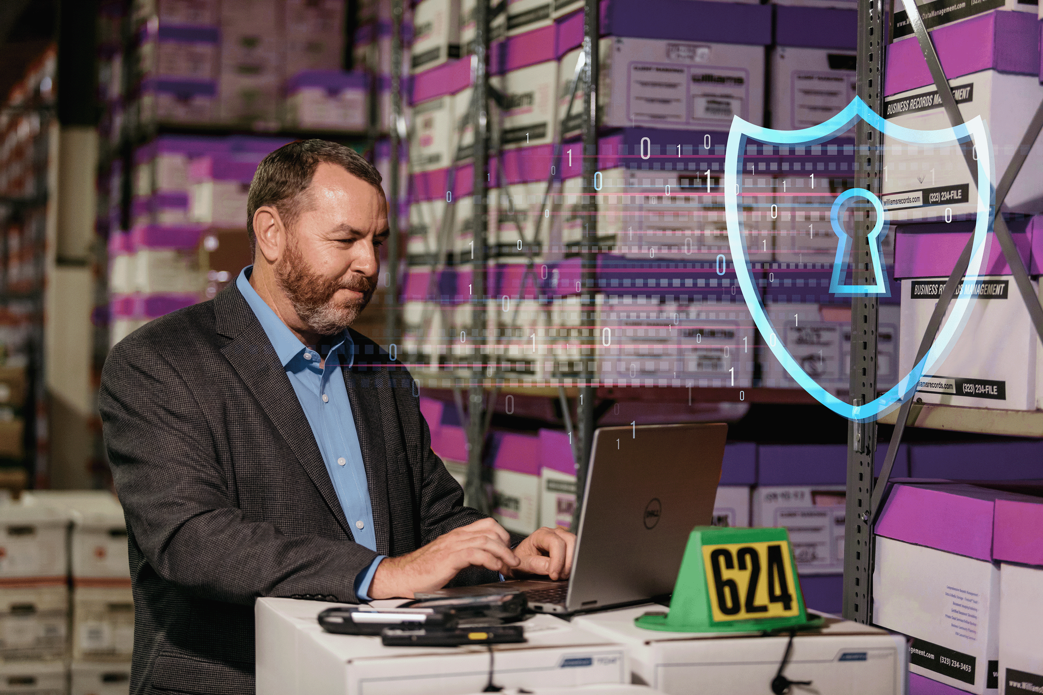 A professional in a warehouse filled with records storage boxes works on a laptop, symbolizing efficient records management. Overlaid on the image is a digital shield with a keyhole, representing robust data privacy and security practices.