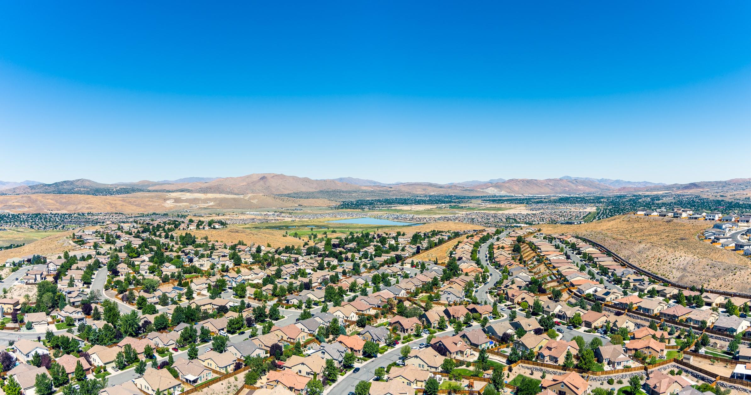 An aerial view of Sparks, Nevada, showcasing a sprawling residential neighborhood with neatly arranged houses and tree-lined streets.